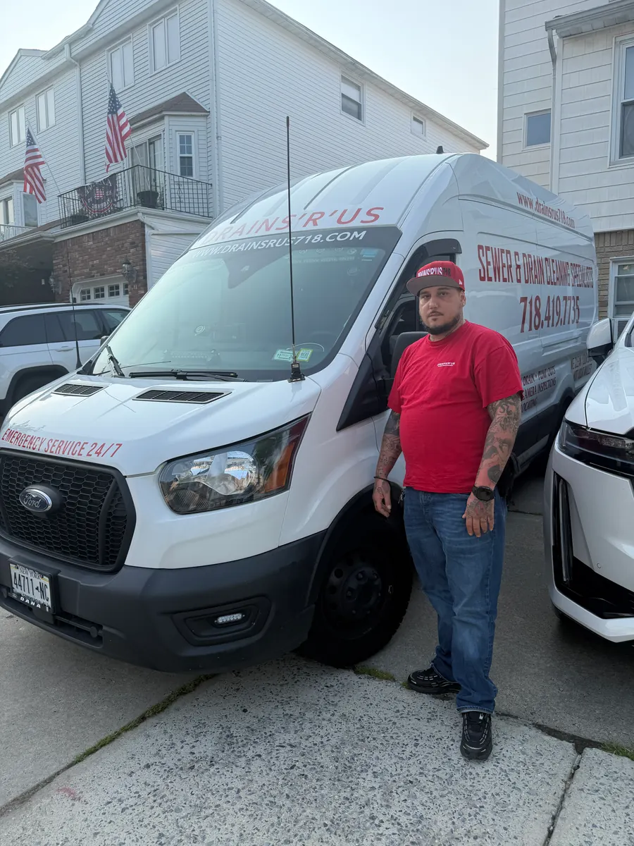Eddie Hernandez, owner of Drains R Us, in front of the company van