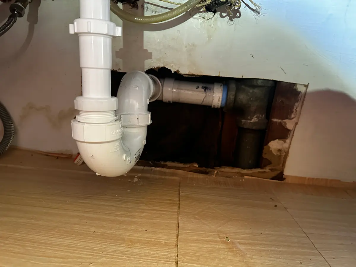 Kitchen sink trap opened up to reach the blockage